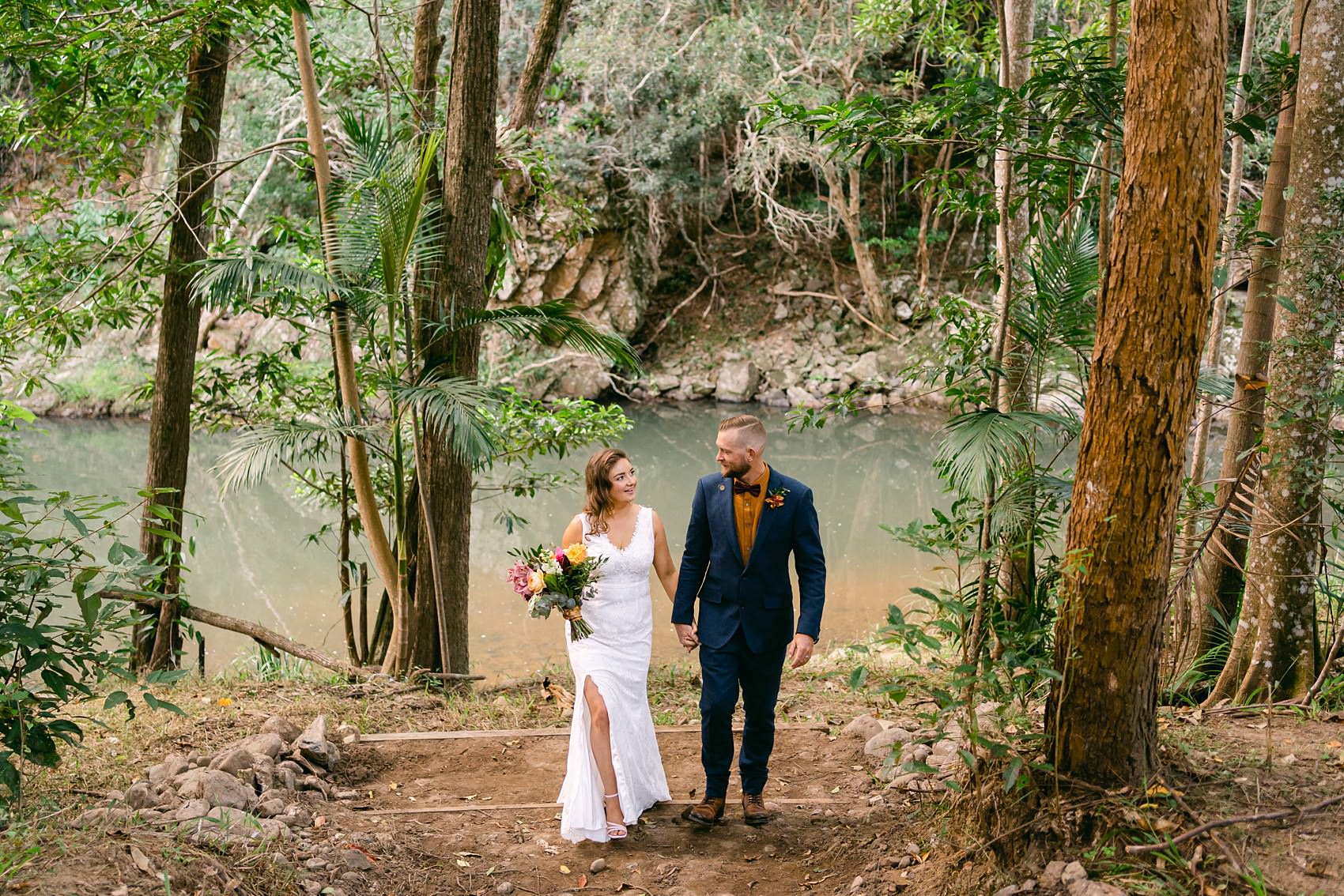 bride and groom walking at the creek Austinvilla Estate