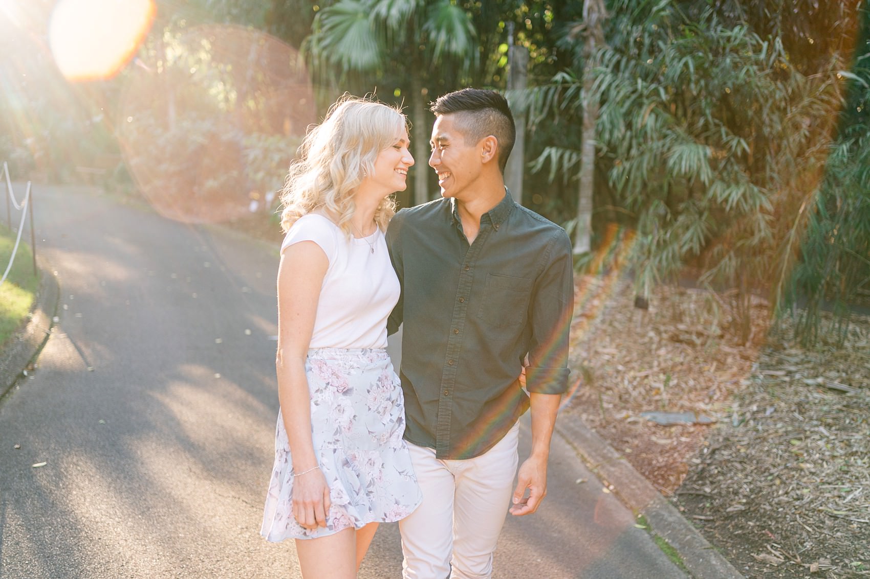 couple smiling together and walking at the mt-coot tha botanic gardens