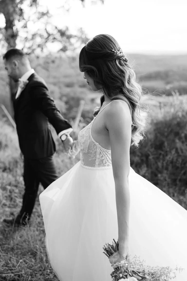 Bride and groom wedding photo while walking on top of a mountain
