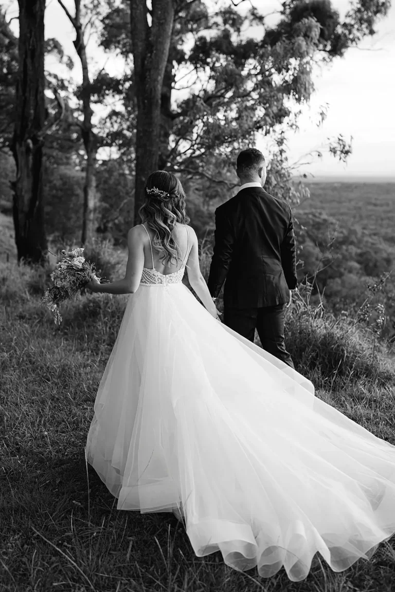 bride and groom walking away on top of the mountain at the rainforest gardens in brisbane